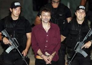 O italiano Cesare Battisti, ex-líder do grupo revolucionário Proletários Armados pelo Comunismo, é escoltado pela polícia ao chegar a Brasília